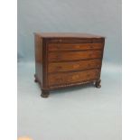 A George III-style inlaid mahogany commode, serpentine-fronted with brushing slide and four