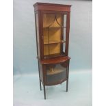 An Edwardian mahogany display cabinet, single astragal-glazed door enclosing lined interior with two