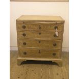 A bleached walnut bachelor's chest, cross-banded top above brushing slide, four graduated drawers