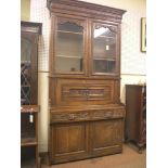 A Victorian oak secretaire bookcase in Flemish style, pair of glazed doors enclosing two