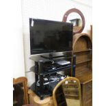 A Panasonic Viera flatscreen television, model TX-L32E5B, 32in. screen, on plate glass stand, with