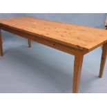 A large pine dining table, plank top with cleated ends, square tapering legs, 7ft. 2in. x 3ft.