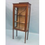 An Edwardian inlaid mahogany display cabinet, lined interior with two shelves enclosed by single