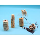 Four carved bone items, including wild animal scent bottle with stopper and two cylindrical bottles,