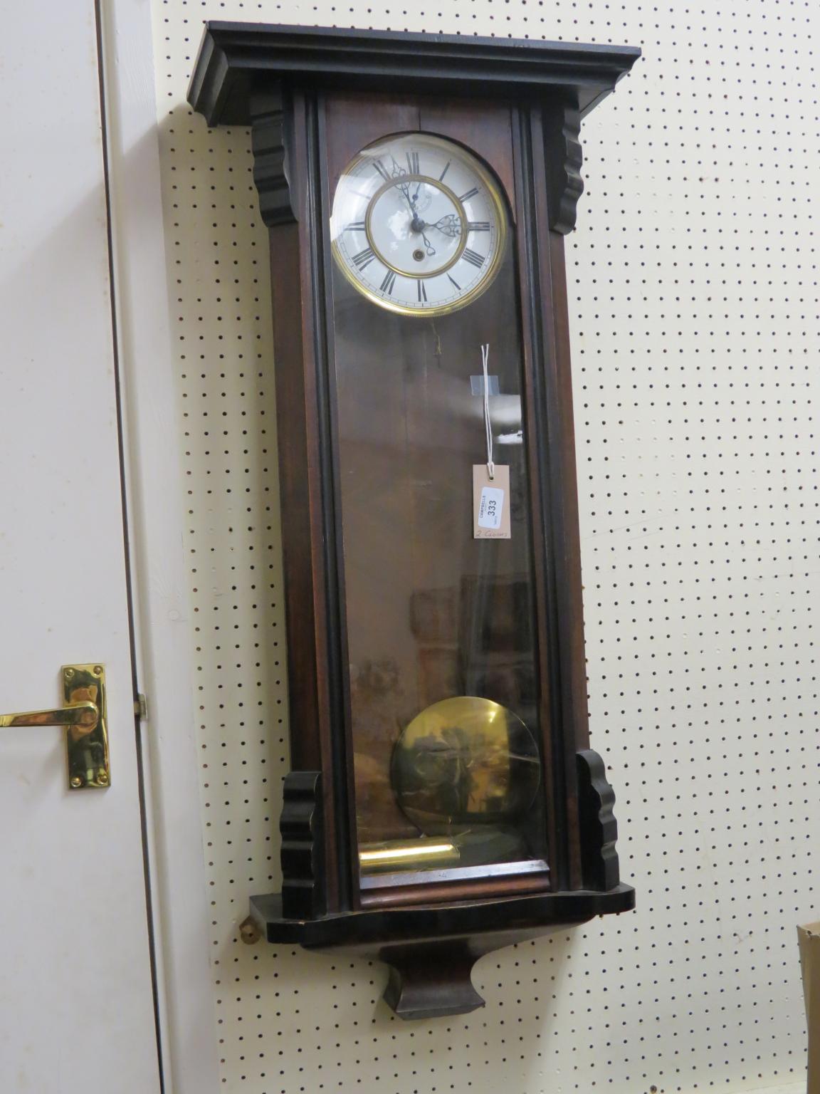 A 19th century Vienna-type wall clock, with enamelled dial, in ebonised walnut case, with a key,