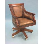 A period-style mahogany desk armchair, upholstered in a buttoned leather, revolving on pedestal
