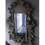 A carved and painted wood mirror, fruit and leaves in high relief, rectangular bevelled plate,
