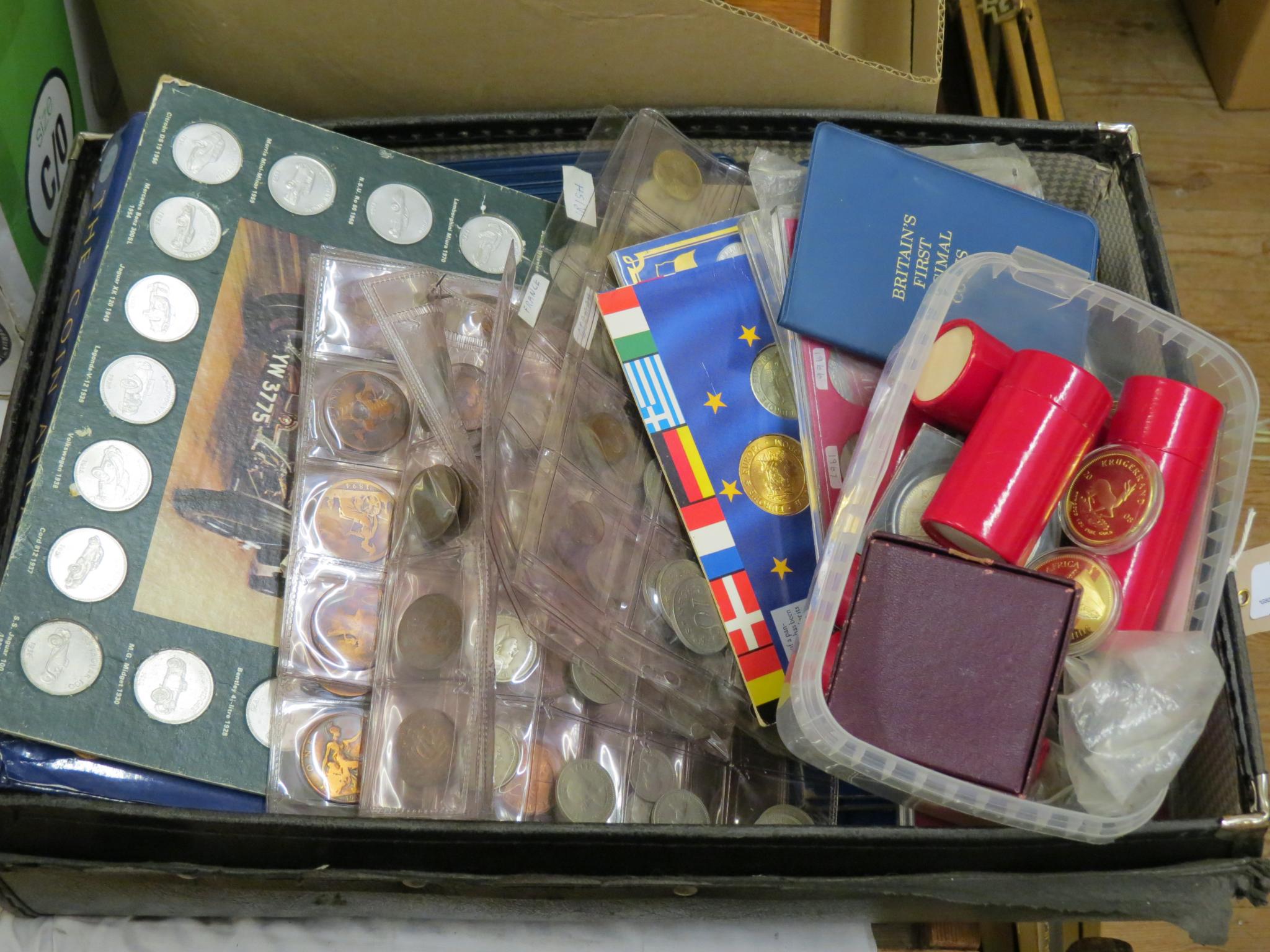 A large collection of world coins, many within display packaging