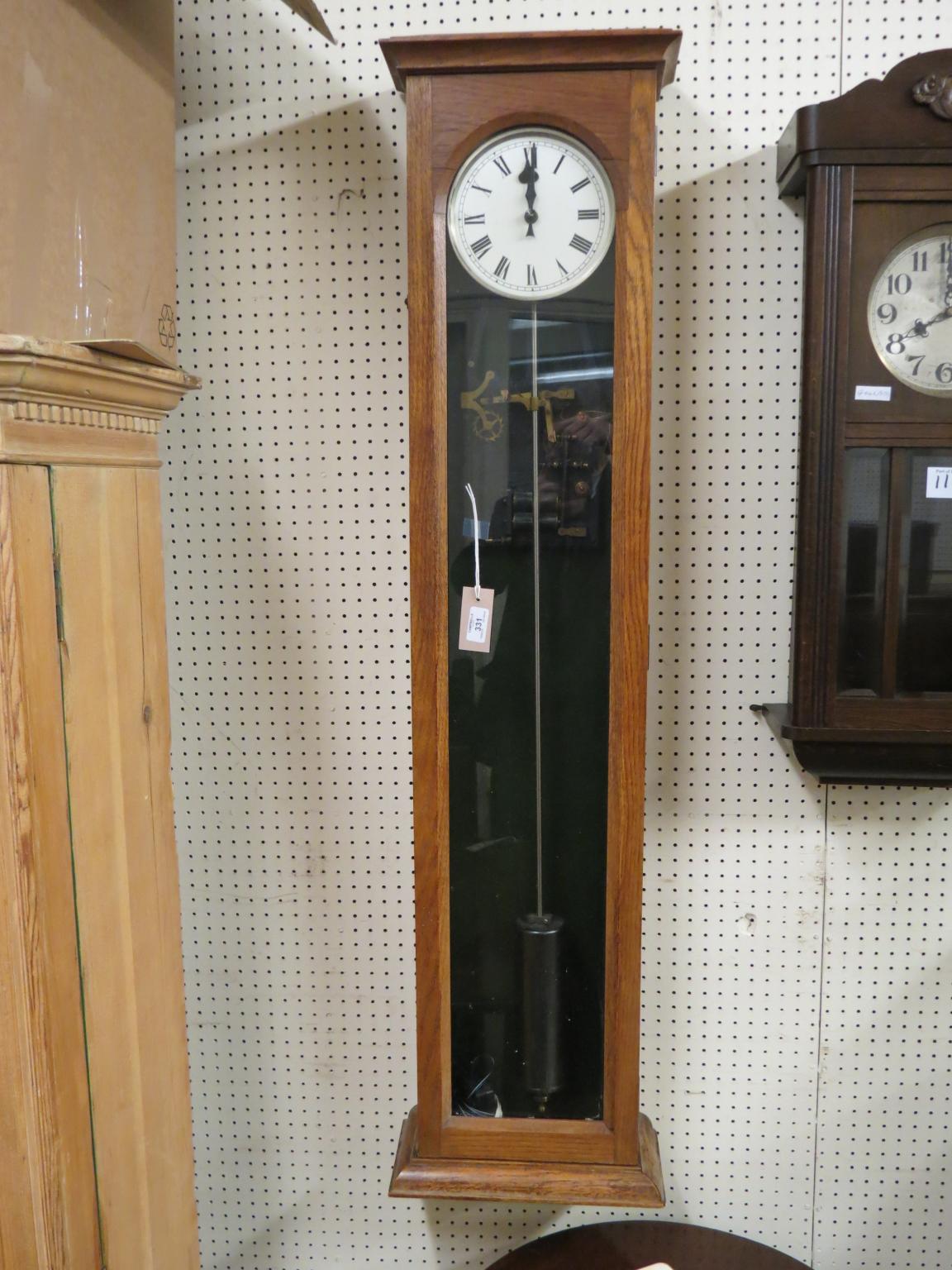 An early electric timepiece, with silvered dial and single glazed trunk door, with pendulum and