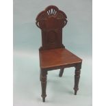 A Victorian mahogany hall chair, carved and pierced back above solid seat and front turned legs