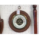 A Victorian aneroid barometer, circular form in rope-twist case