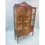 An Edwardian inlaid mahogany display cabinet, central door with convex glass, lined interior with