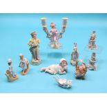 A French bisque figural candelabrum, similar piano baby and eight other related ornaments