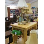 A brass desk lamp, with adjustable green glass shade, three other brass table lamps and a brass