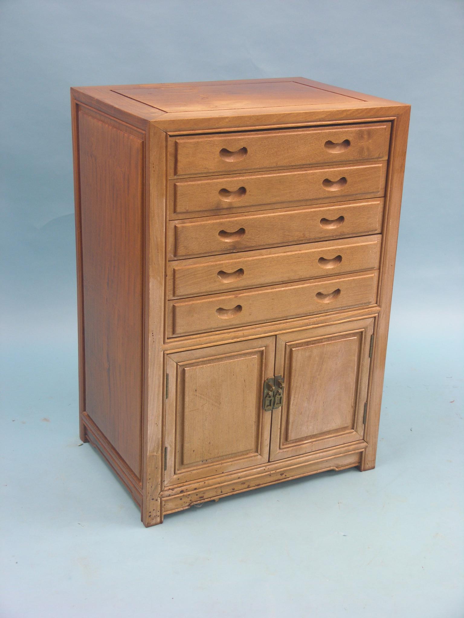 An Eastern hardwood cutlery cabinet, five baize-lined drawers above panelled cupboard, 1ft.