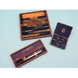 A Victorian mahogany-cased set of drawing instruments, and two further cased drawing instruments