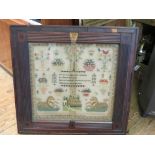 A large early Victorian needlework sampler, featuring potted plants, mythical serpents, house and