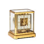 JAEGER-LECOULTRE, "ATMOS". Fine, rectangular, gilt brass and glass Atmos clock wound [...]