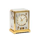 JAEGER-LECOULTRE, ATMOS-WHITE MARINA, "FISHES". Fine, rectangular gilt brass and [...]