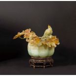 A yellow and russet jade box and cover with branch and bird in relief, China, early [...]