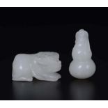 Two carved white jades: a small fruit and a buffalo, China, early 20th century - cm 8 [...]