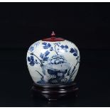A blue and white potiche and wooden cover with floral decoration, China, Qing [...]