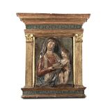 A Madonna with child, a relief in polychrome terracotta within a ciborium frame in [...]