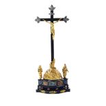 An important Crucifixion group in molten and chiselled bronze, ebanised wood, [...]
