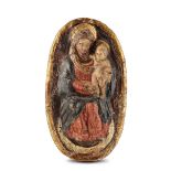 An oval relief depicting the Madonna with Child in painted and gilded papier-mâché. [...]