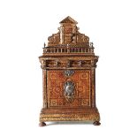 A table coin cabinet in an architectural style, coated in etched leather with gold [...]