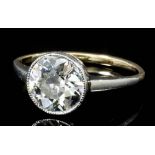 An Edwardian 15ct white and yellow gold mounted diamond solitaire ring, the old cut stone of