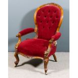 A Victorian lady's walnut framed spoon back open arm easy chair, the moulded showwood frame with