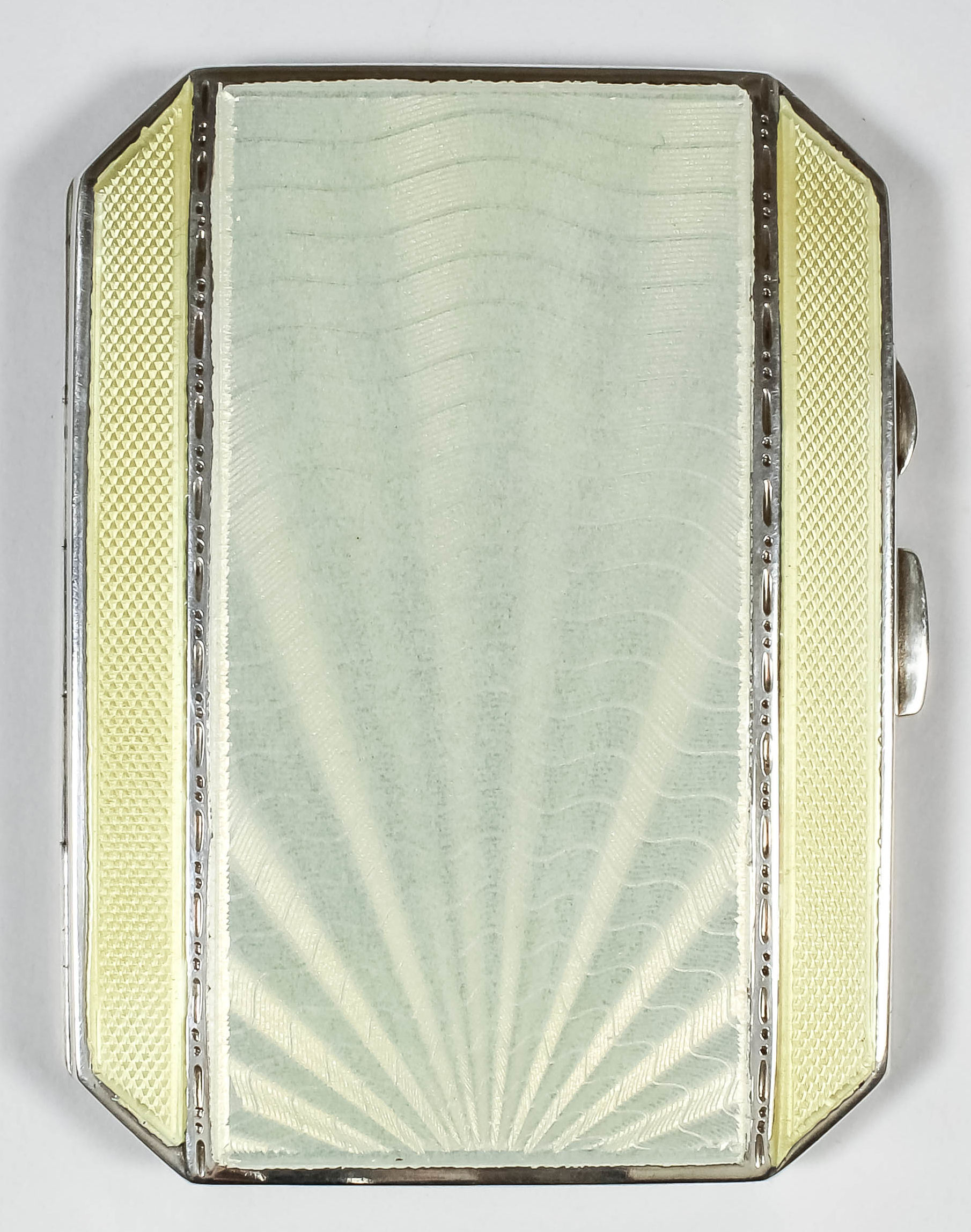 A George V silver cream and yellow guilloche enamel rectangular cigarette case with engine turned