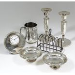 A pair of Elizabeth II silver pillar candlesticks with urn pattern sconces, plain stems and on