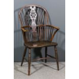 A 19th Century ash and elm seated "wheel back" Windsor armchair, the two-tier stick back with