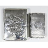 A George V silver rectangular card case/aide memoire, the front and back embossed with five winged