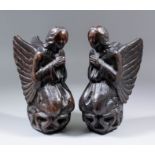 A pair of early 16th Century English carved oak kneeling angels, their hands held together in