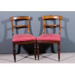 A pair of early Victorian rosewood dining chairs with plain curved crest rails and moulded splats,