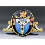 An oak, painted and gilt oval crest carved in relief with the Arms of the Archbishop of
