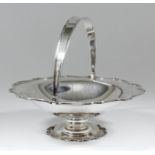 A George V silver circular fruit basket of shaped and reeded outline, on conforming foot rim, 9.