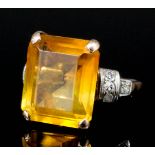 A 1920's gold coloured metal mounted topaz and diamond ring, the rectangular cut topaz of