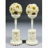 Two Chinese carved ivory puzzle balls, each 2ins diameter, with matching carved ivory stands, 6.