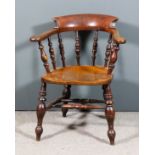 A late Victorian ash and elm seated "Smoker's Bow" armchair, the low horseshoe pattern back on