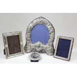 An Elizabeth II silver heart shaped photograph frame, the whole embossed with cartouche, scroll