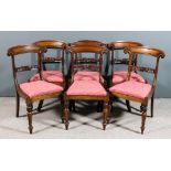A set of six William IV mahogany dining chairs with shaped and panelled crest rails, scroll carved