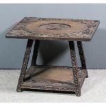 A Chinese carved hardwood square two tier occasional table, the top carved with the crest of the "