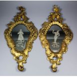 A pair of 18th/19th Century Italian carved giltwood mirrors of rococo outline, the plates engraved