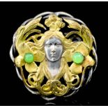 A gold and silvery coloured metal mounted jadeite set circular pattern brooch in the "Art Nouveau"