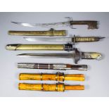 Three 20th Century Oriental eating sets each 13ins overall, and three 20th Century Oriental daggers