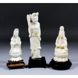 A Chinese carved ivory figure of Guanyin seated on a lotus pattern throne, 4.75ins high, a smaller